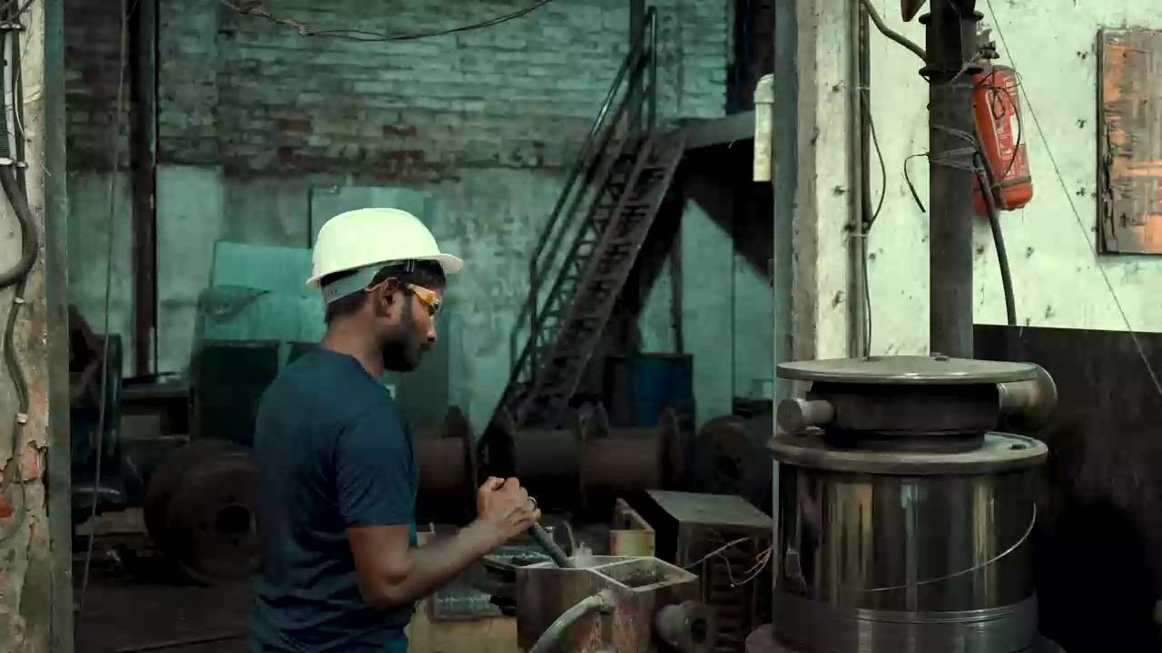 A technician at a wire spool on the Swiss Wire production floor